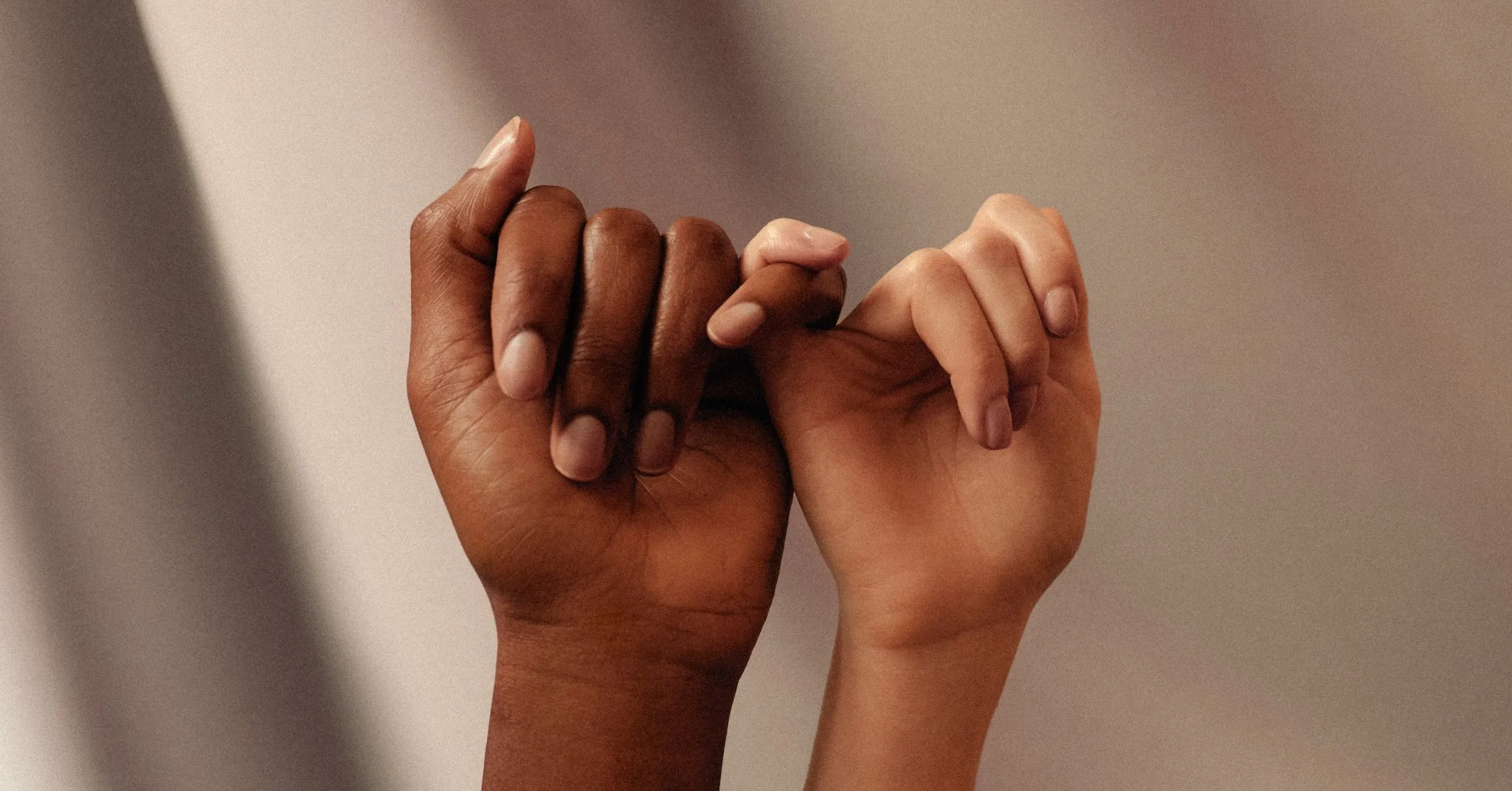 Two people linking little fingers