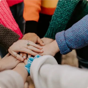 A group of colleagues stacking their hands together