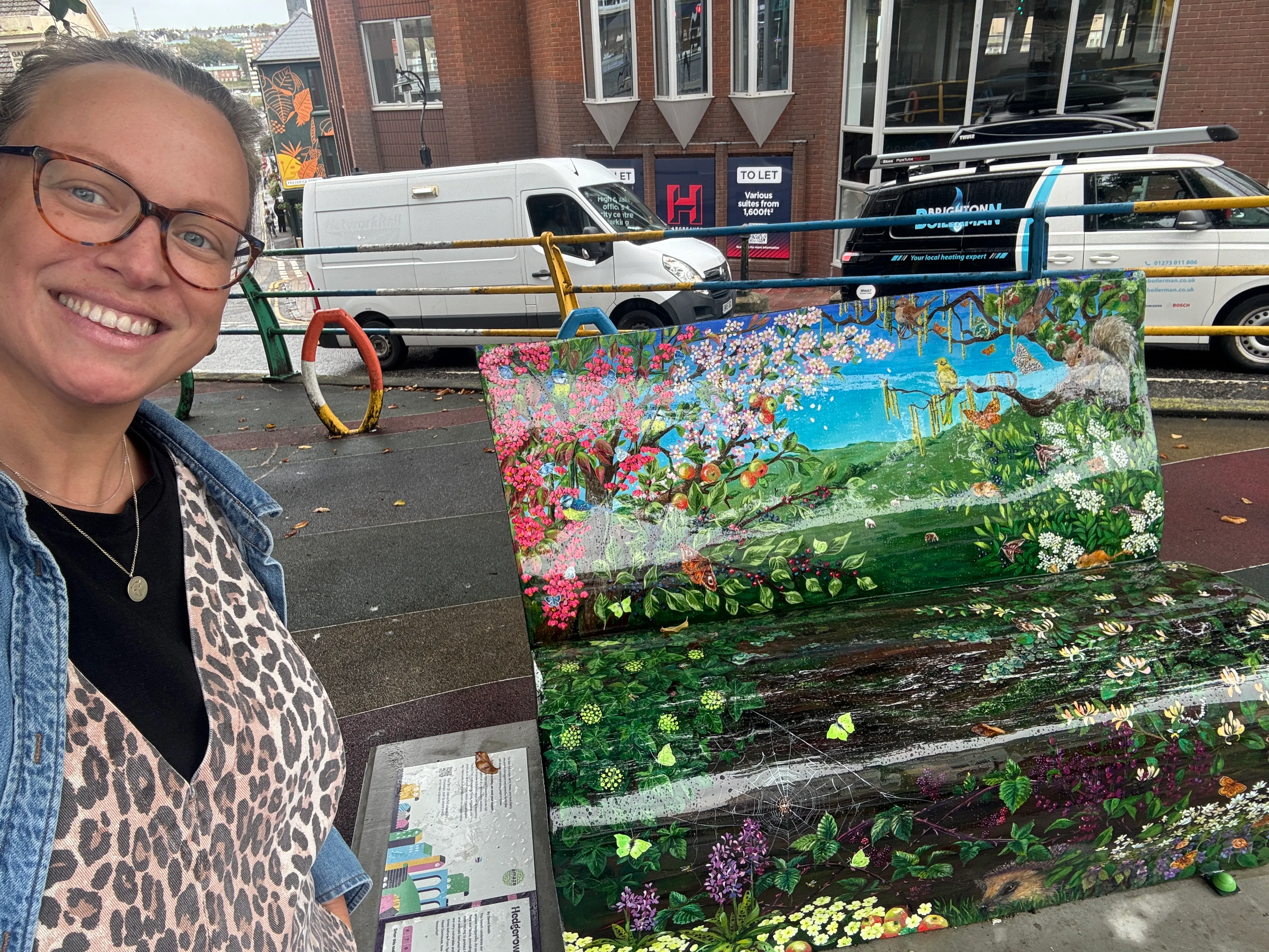 Catrina Baker-Bassett beside Hedgerow Haven, the wildlife-themed BookBench sponsored by DabApps