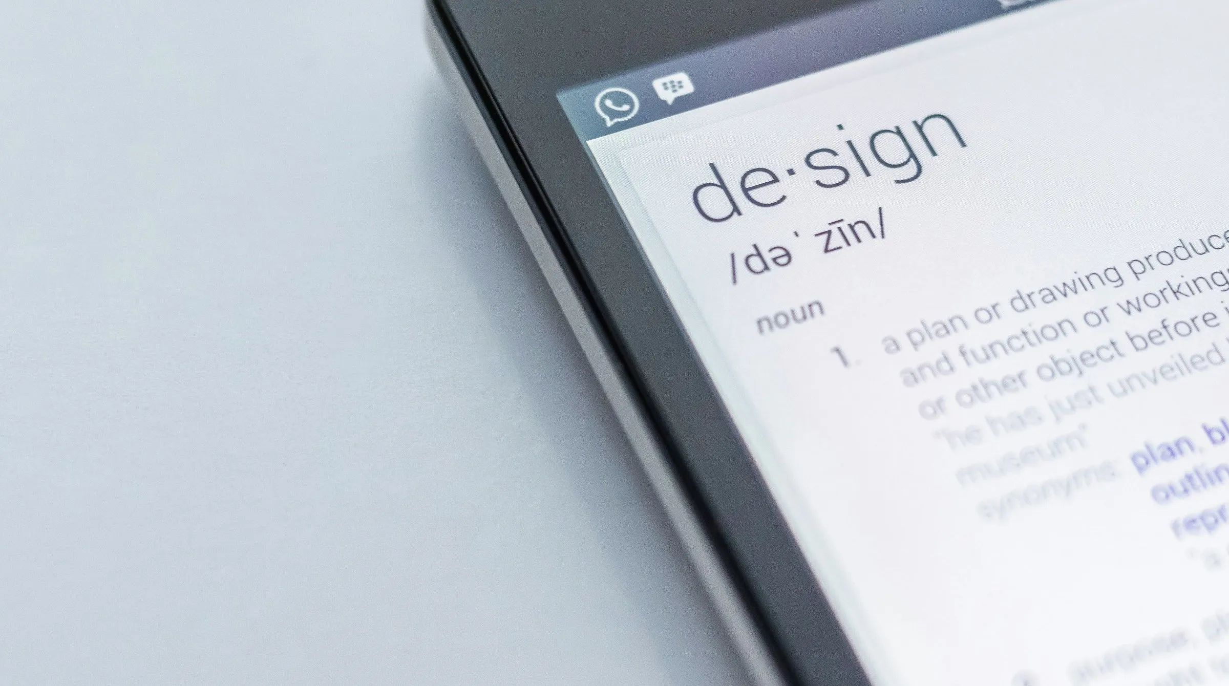 The word design and its definition displayed on a screen