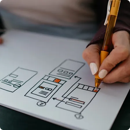 A hand sketching mobile app wireframes