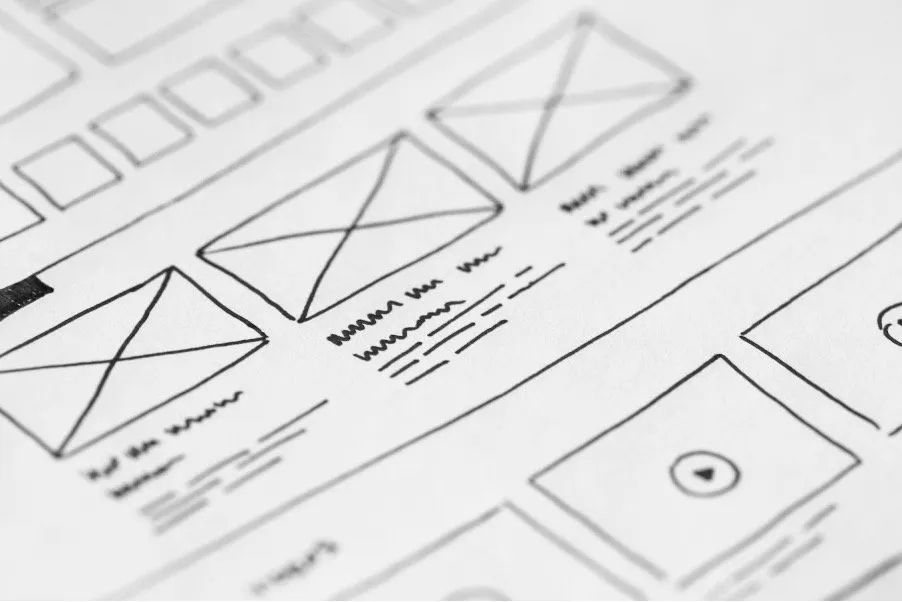 Hand-drawn website wireframes on paper