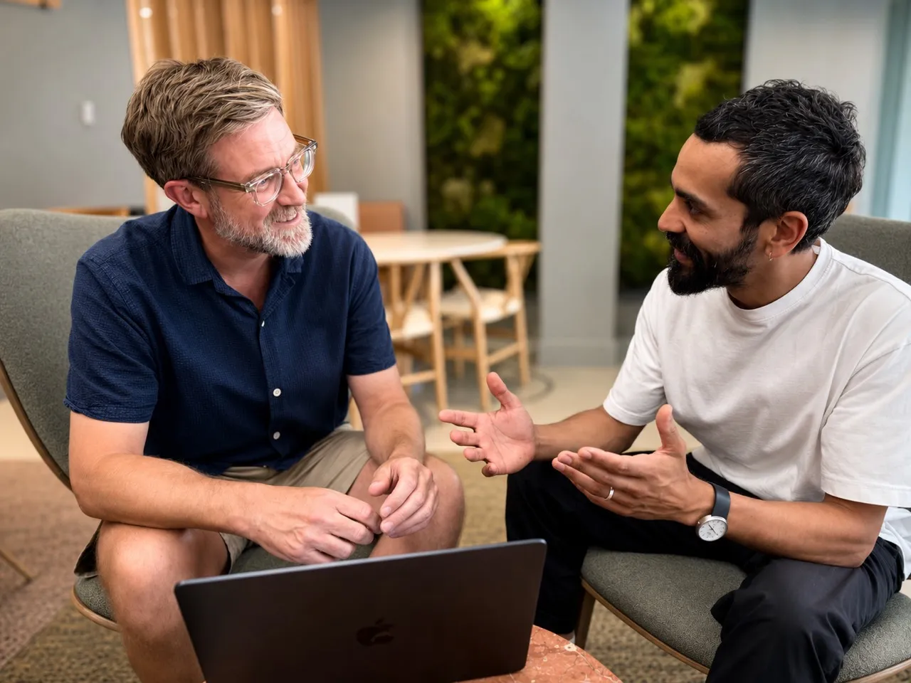 Mark and Ed discussing work over a laptop