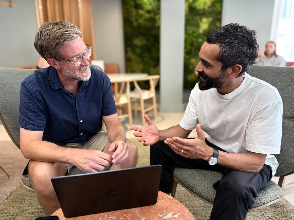 Mark and Ed discussing work over a laptop