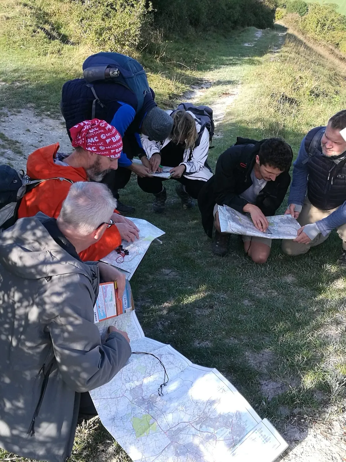 The DabApps team consulting maps beside a South Downs path